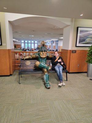 Sparty statue with a visitor.