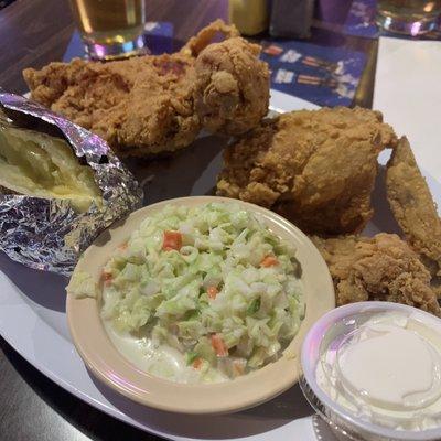 Fried Chicken dinner with baked potato and coleslaw.