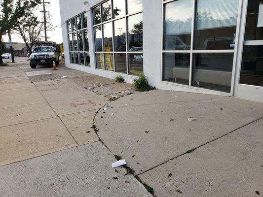 Trash all over the sidewalk.