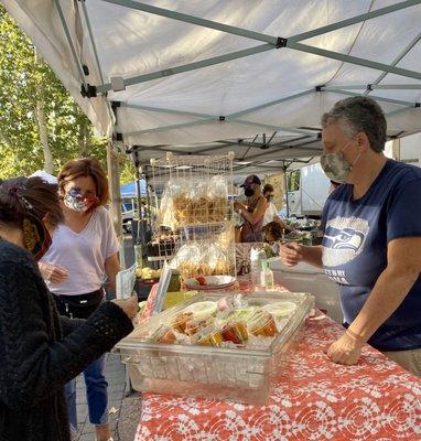 The owner Sue selling her homemade hummus to some lucky guests.