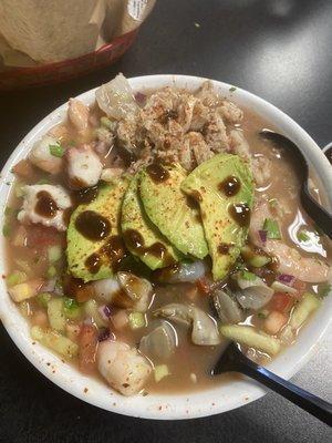 Cocktails Mixto. Shrimp (cooked) Shrimp curtido, octopus, sea snail, fresh crab, and veggies. Topped with avocado and spicy tangy sauce.