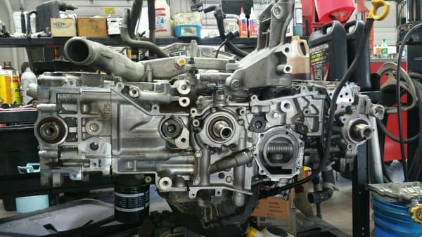 This is a 2.5L SOHC Subaru engine removed from the vehicle. The cylinder heads are still on the engine, but the timing belt, ...