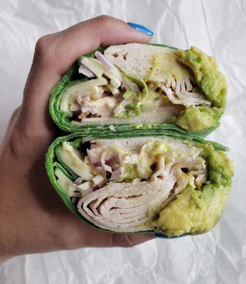 Turkey, Cooper Sharp, Shredded Lettuce, Red Onion, Avocado and Salsa Mayo on a Spinach Wrap