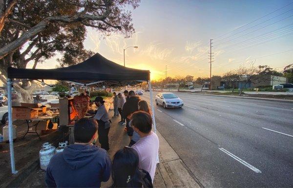 Roadside pop-up restaurant complete with cars whizzing by.