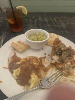 Fried chicken with crawfish sauce, mashed potatoes, Butter beans, French bread and