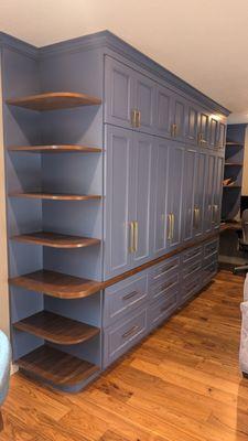 Custom cabinets with wrap-around built-in desk and adjustable corner shelves [side view]