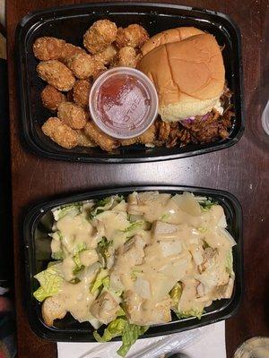 Pulled pork sandwich with tots and Caesar salad