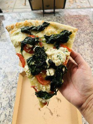 Delicious pizza slice with spinach, tomatoes, and ricotta cheese @ Mama Lucia