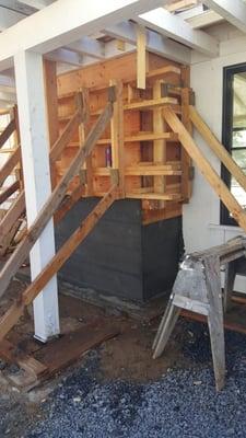 Board form concrete exterior chimney.  Stripping forms