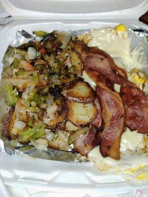 Breakfast with pork bacon, home fries and cheese eggs