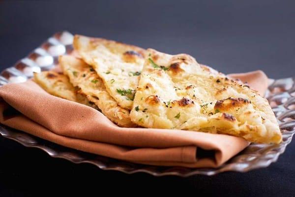 Naan...Flat bread baked in a tandoor. Choose from Classic, Chili, Garlic, Onion, Lachha Paratha, Cheese Kulch, and Peshawari varieties.