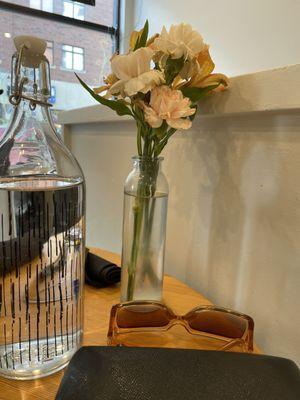 Fresh flowers at the table and water pitcher