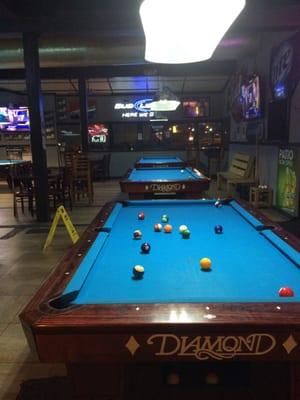 A few of the pool tables in the corner