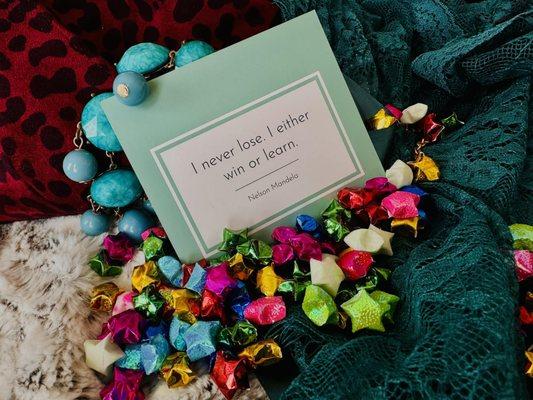 The quote card surrounded by choice fabrics/props from the photoshoot