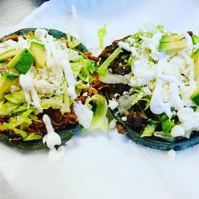 These are sopes also made from blue corn. They put beans your choice of meat, lettuce, cheese, sour cream and avocado.