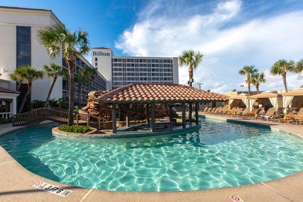 Outdoor heated pool with tropical swim-up bar and grill