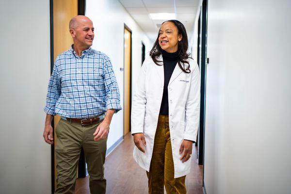 Dr. Tutt walks with a patient in the hallway