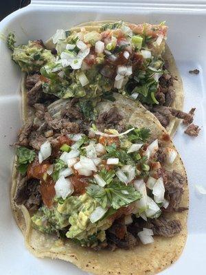 Two tacos grandes de Asada with Guacamole.