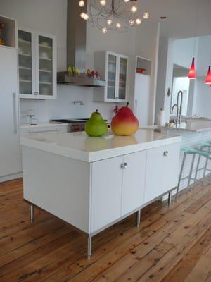 Metallic White Paint. Porcelain Slab Counter Tops. Chiseled Walnut Floors.