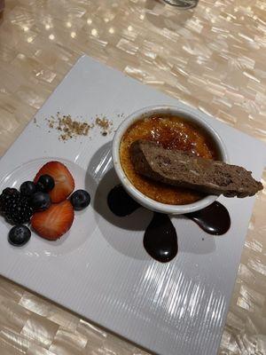 Creme brûlée and biscotti with a side of fruit and chocolate