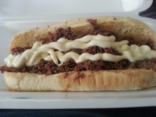 Steak sandwich with cheese and mayo.