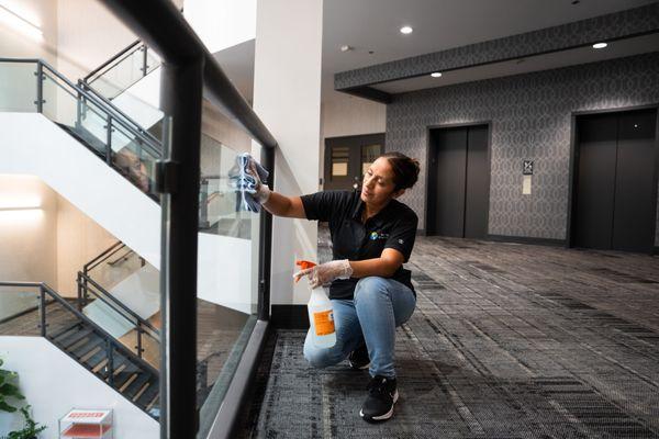 Employee Cleaning Glass