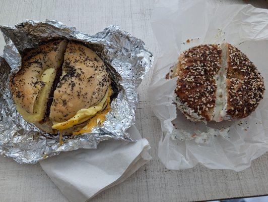 Side by side of bacon egg and cheese and a toasted everything seasoning bagel with cream cheese