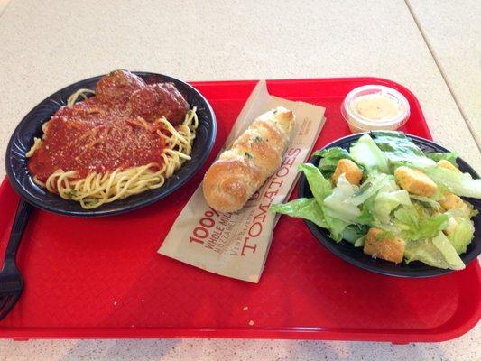 Spaghetti with meatballs, breadstick, and a salad