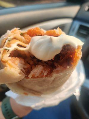 Birria burrito with crema