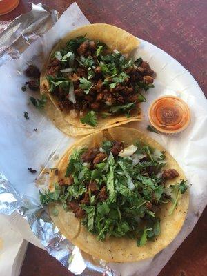 Tacos al pastor with cilantro , onions. Tasty tasty