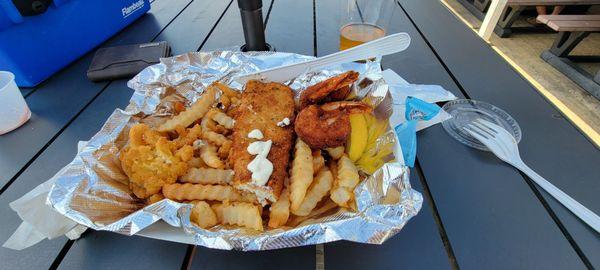 Seafood platter with fried fish, clams, and shrimp