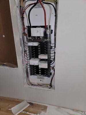 Installing breakers, trim out on new home