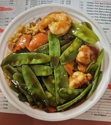 Shrimp with snow peas and fried rice.