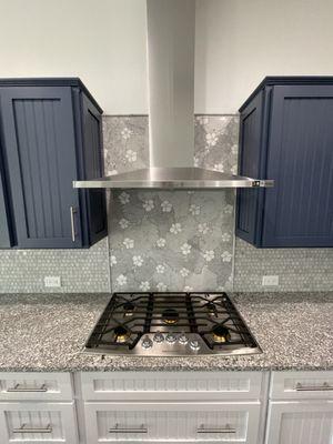 A custom designed water jetted marble backsplash.