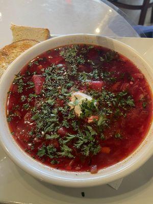 Borscht with a dollop of sour cream and fresh toasted bread.