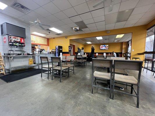 Plain Jane dining room, concrete floors and fluorescent lighting. Clean-ish