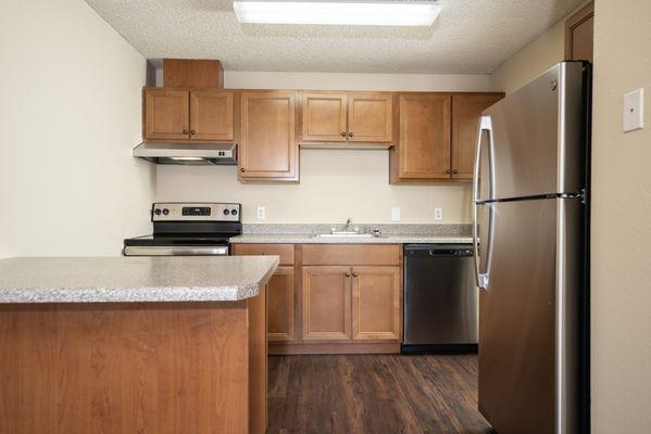 Kitchen with modern stainless steel appliances and ample cabinet space.