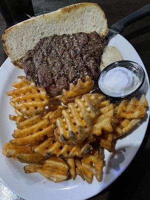 Steak ribeye sandwich and waffle fries