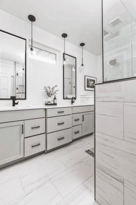 Bathroom design with vanities, flooring, and shower tile