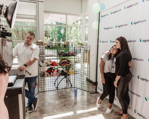 Signify Health employees post in the photo booth during an employee appreciation event.