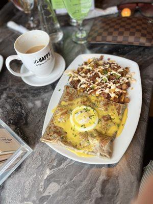 Shrimp Benedict crepe with loaded potatoes for a side.