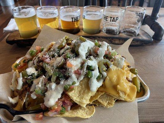 Chorizo nachos with extra cheese and a beer flight of my selection.