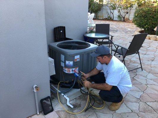 Technician working hard on Condenser Unit