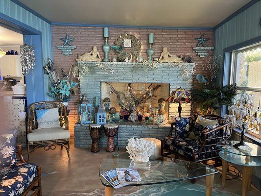 Sitting room with fireplace deorated with beautiful mermaids and other charming pieces