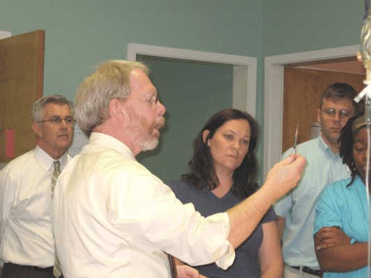 Staff meetings at IAH include guest speakers like Dr. Brunson, renowned veterinary anesthesiologist.