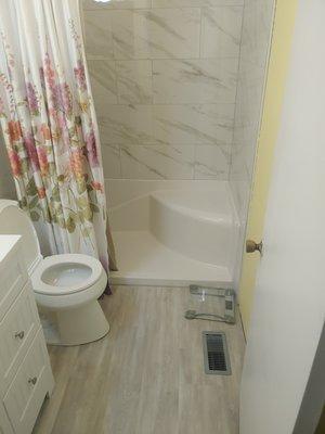 Final image of completed bathroom(installed shower stall, tile on walls, vinyl flooring) (bathroom 4 of 4)