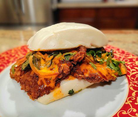 Fried Chiclen Bun had Taiwanese curry fried chicken filets, spicy mayonnaise, cilantro, mint leaf, pickles, red onions, and cucumbers.