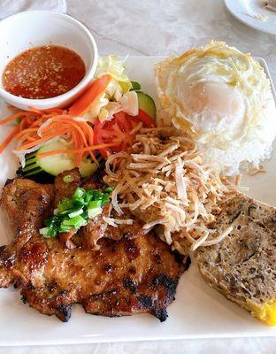 Broken rice with pork chop, egg, shredded pork skin, and vietnamese meatloaf.