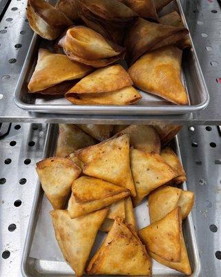 Samosas with different types of fillings such as beef, veggie, and spinach/ cheese.