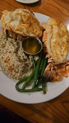 Two lobster tails and rice pilaf